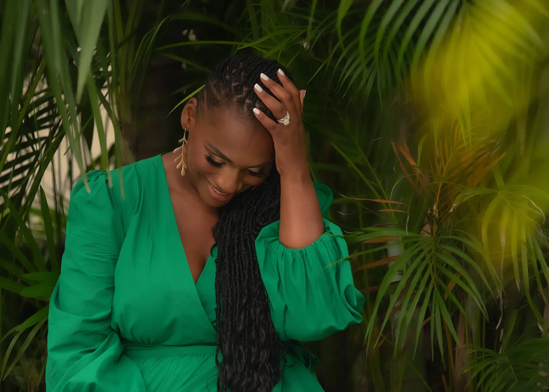 Black woman, braids,tropical, green dress, looking down